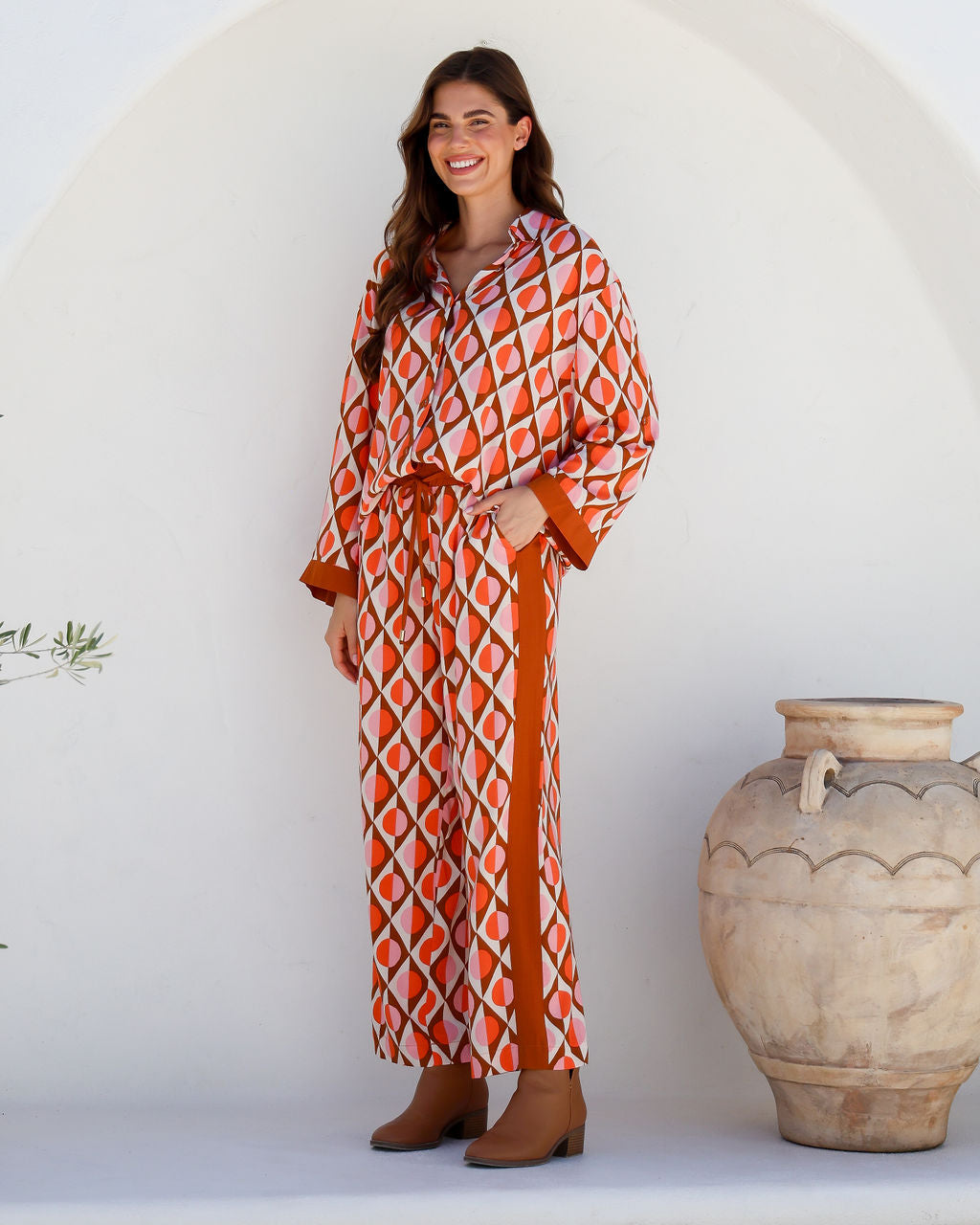 the arely pant by label of love are bright coloured pull on elastic waist pants in a geo print and contrast stripe down the side and part of a matching pant set