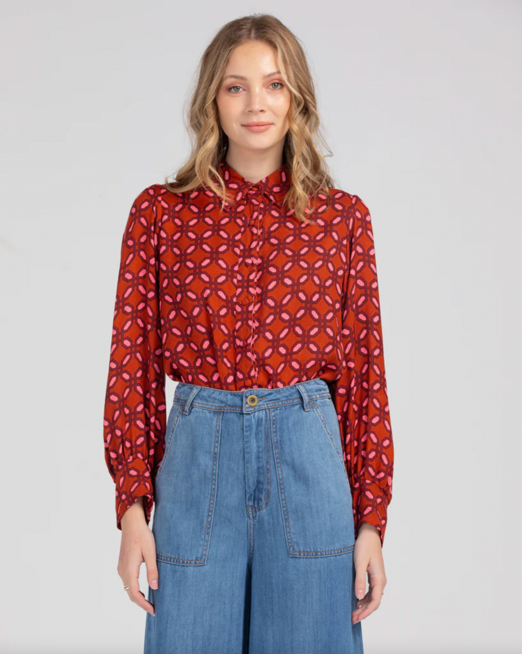 the ally shirt by boom shankar is a bright red and pink geometric retro printed boho button up long sleeve top made ethically in india