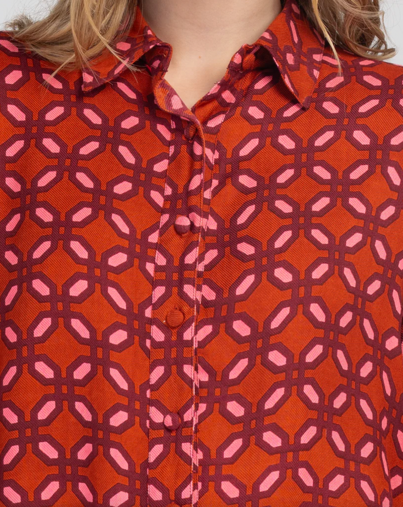 the ally shirt by boom shankar is a bright red and pink geometric retro printed boho button up long sleeve top made ethically in india