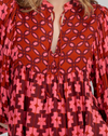 The noel top by boom shankar is a peasant style boho blouse with a pink and red retro geometric pattern and ballon sleeves