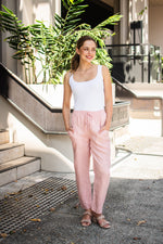 relaxed pink linen pants with an elastic waist and pockets