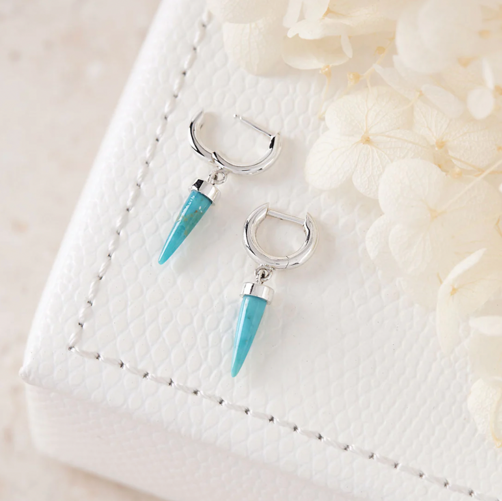 sterling silver huggie earrings with a turquoise pyramid drop by midsummer star jewellery