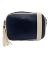 a navy blue vegan leather cross body bag by zjoosh with ecru contrast piping and straps