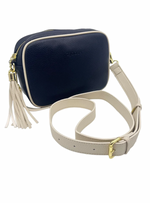 a navy blue vegan leather cross body bag by zjoosh with ecru contrast piping and straps