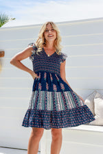 the sophie smoking dress by joop and gypsy is a summer boho navy floral teired dress with a shirred bodice