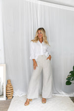 The Jude Linen pants by Little Lies are a wide leg linen pants in natural with zip and button closure and side pockets 