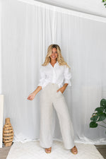 The Jude Linen pants by Little Lies are a wide leg linen pants in natural with zip and button closure and side pockets 