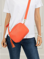 Ruby sports crossbody vegan leather bag by zjoosh in orange with contratsting adjustable straps