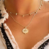 a 18 karat yellow gold plate necklace with a blooming lotus design pendant