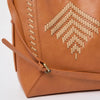 a vegan leather tan coloured shoulder bag with woven design on the front