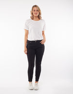 a mid rise skinny leg super soft and stretchy black pair of button up jeans