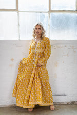 the Goa dress is a marigold yellow coloured cotton block print maxi dress with a long sleeve and border detail by Jipsi Cartel