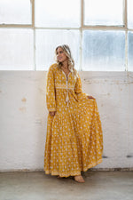 the Goa dress is a marigold yellow coloured cotton block print maxi dress with a long sleeve and border detail by Jipsi Cartel