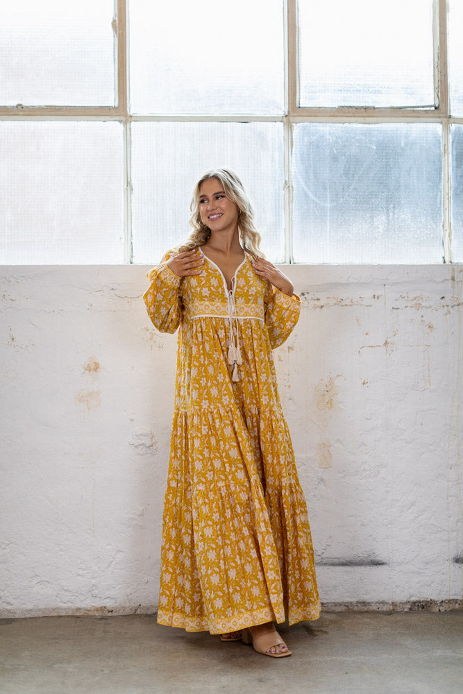 the Goa dress is a marigold yellow coloured cotton block print maxi dress with a long sleeve and border detail by Jipsi Cartel