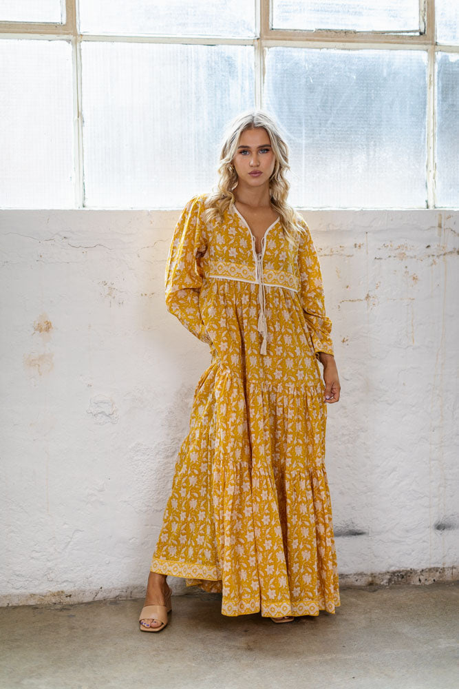 the Goa dress is a marigold yellow coloured cotton block print maxi dress with a long sleeve and border detail by Jipsi Cartel