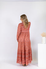 a 70's inspired vintage bohemian floral maxi dress made from rose pink cotton block print
