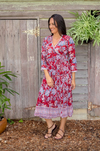 the genevieve dress is a soft cotton hand block printed midi length wrap dress in a red floral design by soul song
