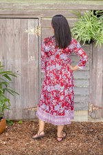 the genevieve dress is a soft cotton hand block printed midi length wrap dress in a red floral design by soul song